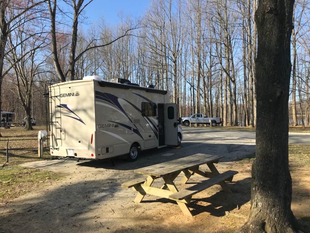 motor home in trees at pond setting