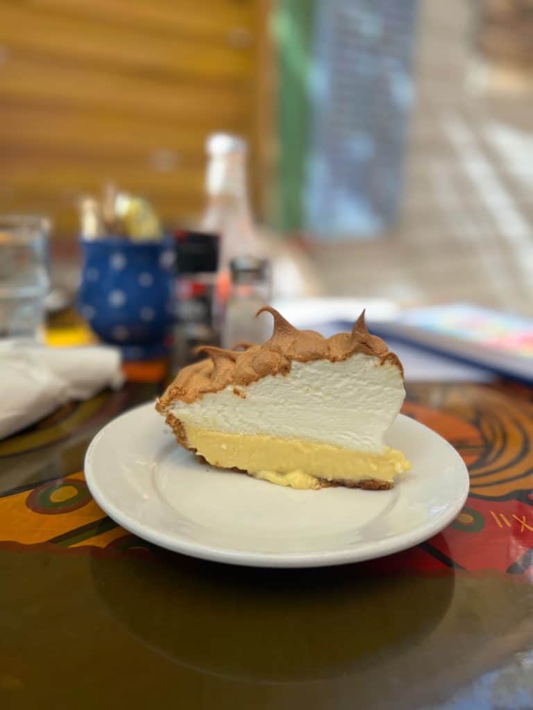 A slice of puffy meringue style key lime pie on a plate at Blue Heaven restaurant in Key West