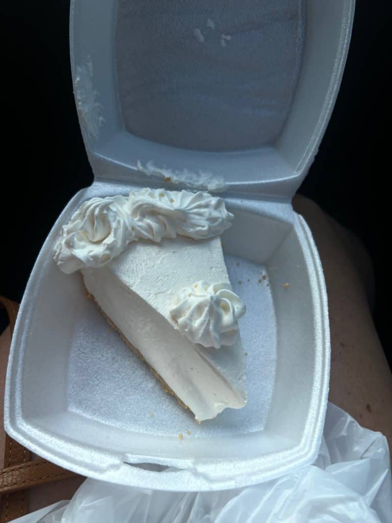 Take out box with a fluffy slice of pale key lime pie