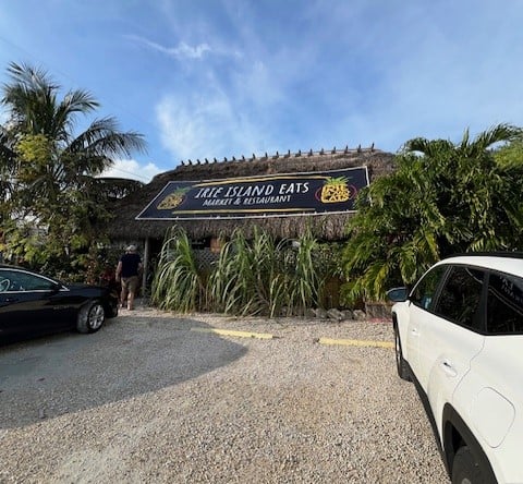 Exterior image of the thatched roof tiki style building where Irie Eats is located.