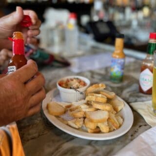 appetizer with sauces and person's hand