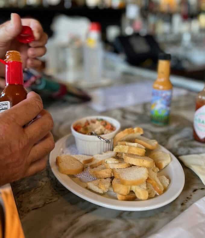 appetizer with sauces and person's hand