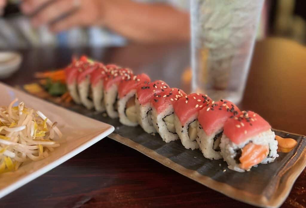 a sushi roll with tuna on top