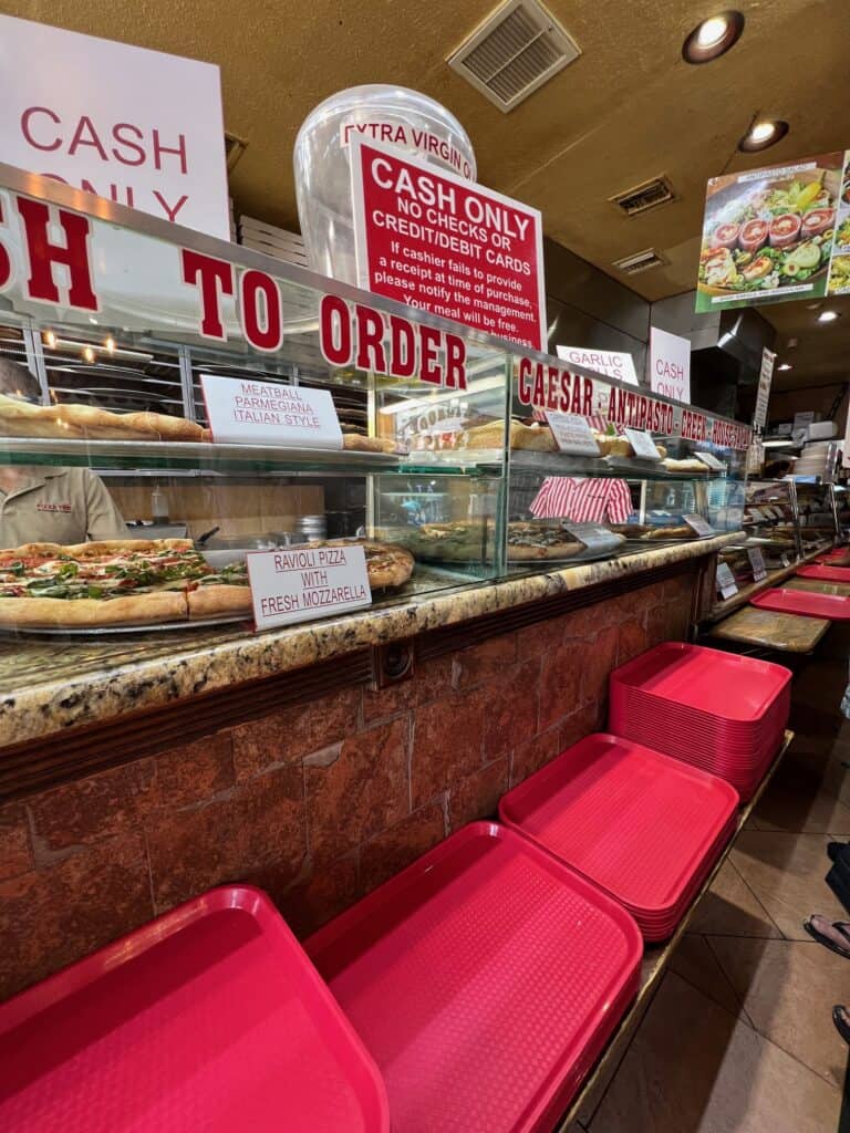 the line up and case of pizza offerings at Pizza Time in St. Augustine