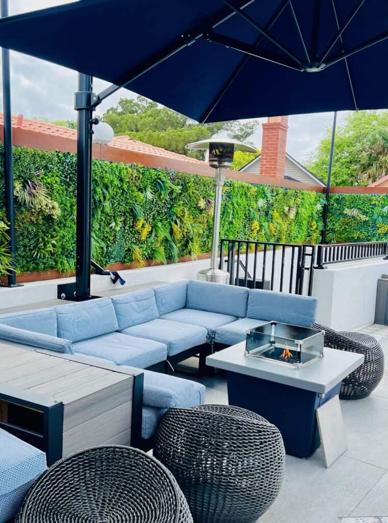 Image of cray outdoor couchh fire pit and umbrella at River + Fort roofdeck