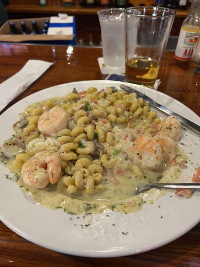 a plate of seafood pasta with shrimp an cream sauces