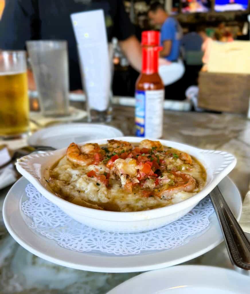 shrimp and grits in a white ceramic bowl