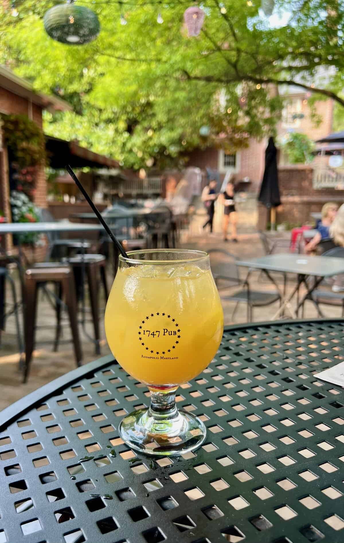 Yellow cocktail in a 1747 Snifter Glass at Reynolds in Annapolis