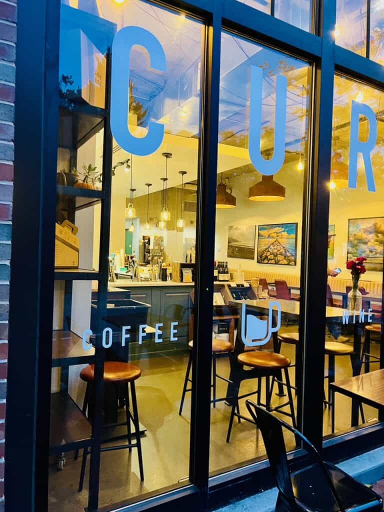 Exterior window looking into Curate a coffee and wine bar on West Street in Annapolis, MD.