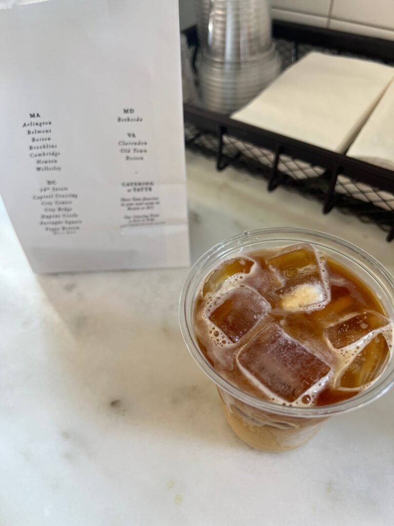 Iced coffee on the counter next to a menu