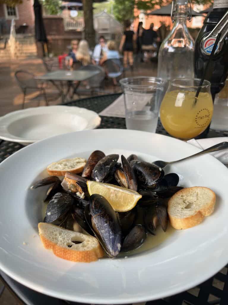 Bowl of mussels broth, and bread.
