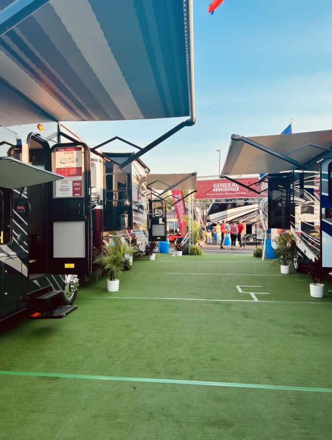 View of RVs set up and on display at the Hershey RV show with General RV signs.