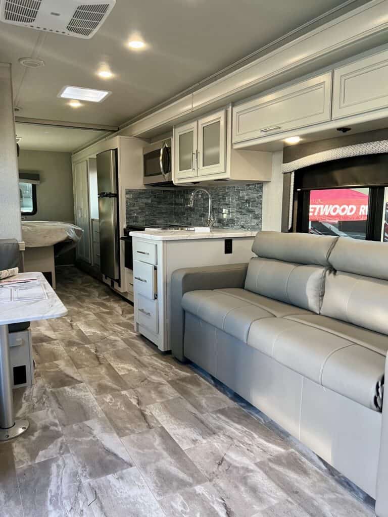 Gray and white interior photo of a motor home at the RV Show